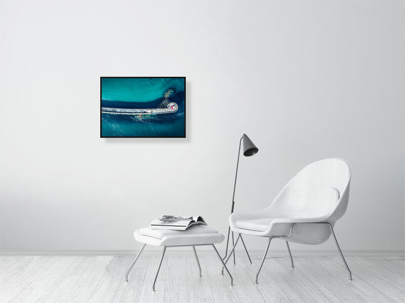 Aerial view of Newhaven lighthouse and wave breakers in clear, blue waters. Print or framed photography art.