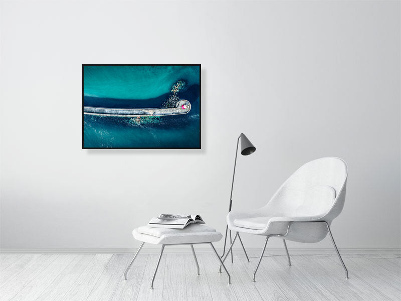 Aerial view of Newhaven lighthouse and wave breakers in clear, blue waters. Print or framed photography art.