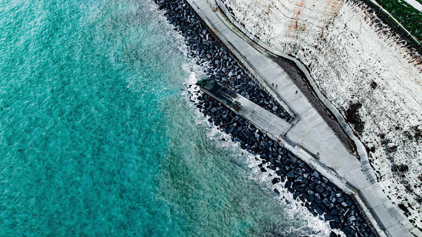 Walk right by the unrest waters of Rottingdean beach on a cold day. Print or framed photography art.