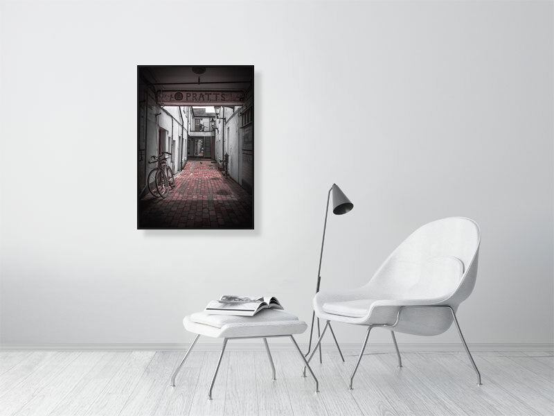 Quiet alleyway with vintage bicycle parked up. Print or framed art photography.