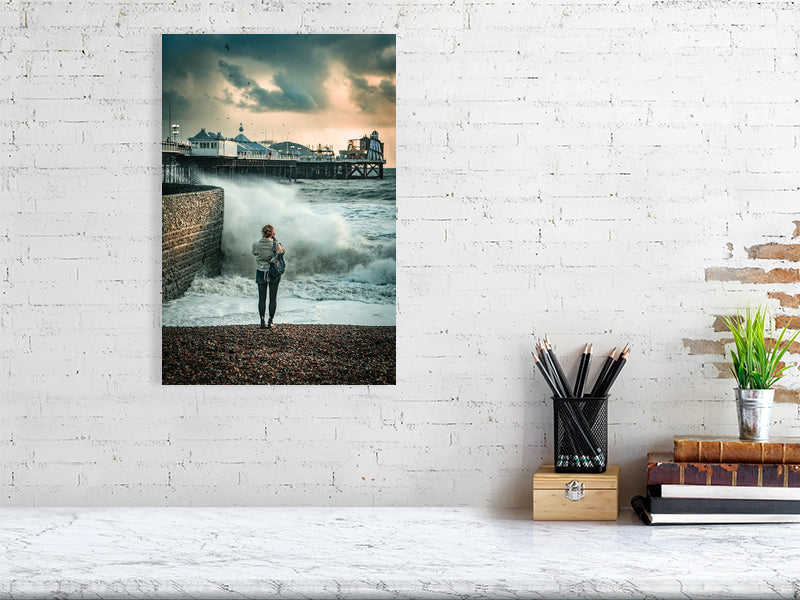 Random spectator watching waves on a windy autumn day by Brighton Pier. Print or framed photography art.