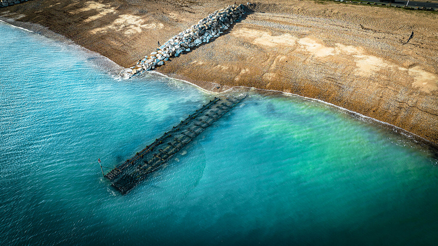 Aerial view of clear waters of West Sussex beach. Print or framed photography art.