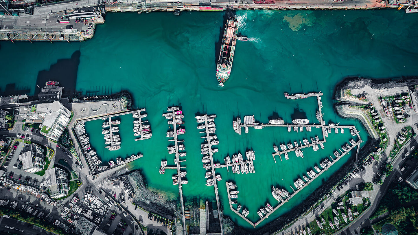 Arrival or departure of a cargo ship in a city port. Print or framed photography art.