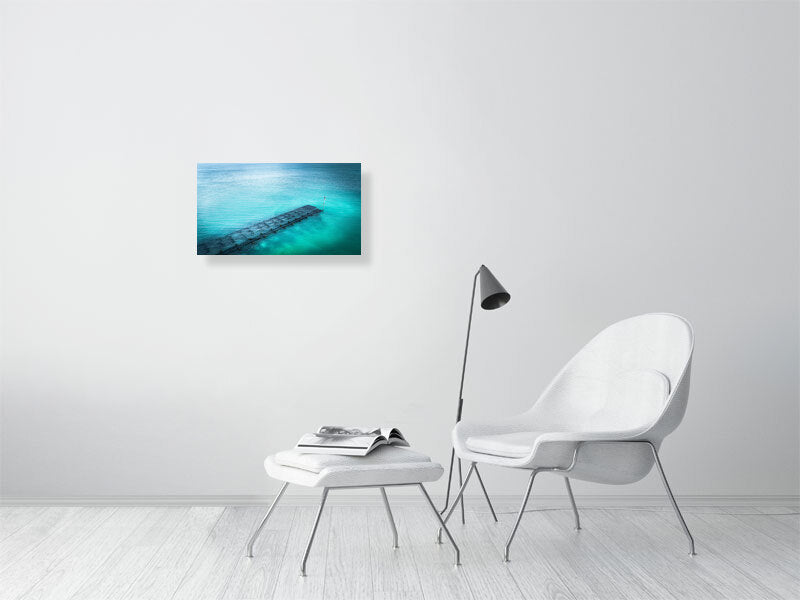 Blue waters of Lancing beach with remains of some wooden structure. Print or framed photography art.