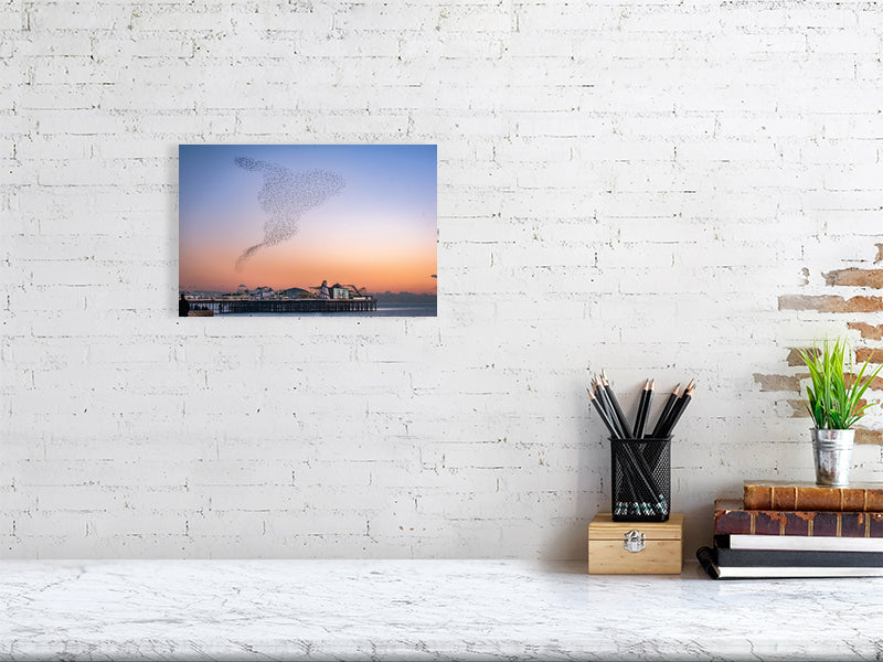 Starling Murmuration over colourful Brighton Pier on a calm sunny evening. Print or framed photography art.