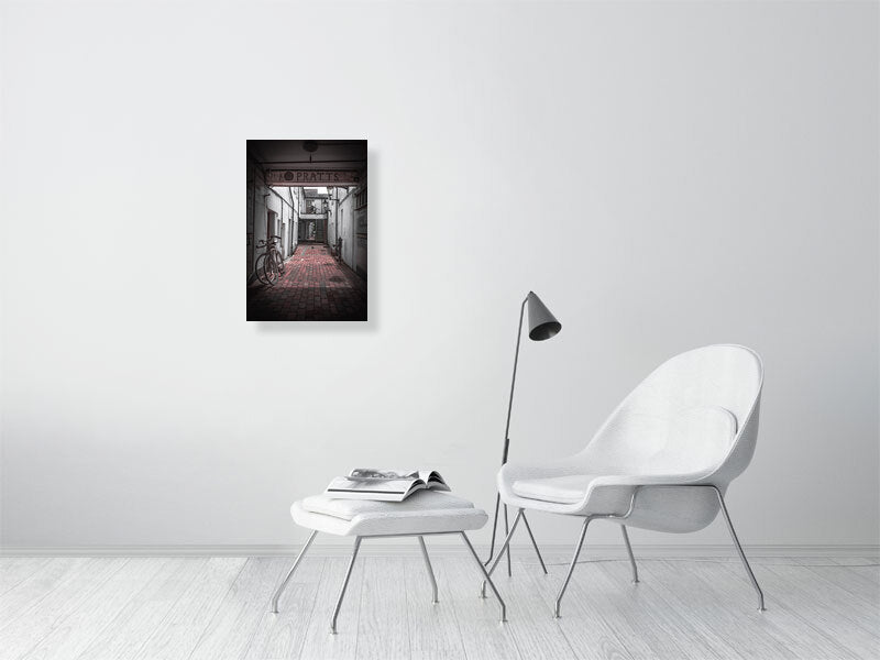 Quiet alleyway with vintage bicycle parked up. Print or framed art photography.