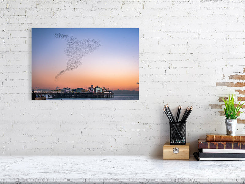 Starling Murmuration over colourful Brighton Pier on a calm sunny evening. Print or framed photography art.