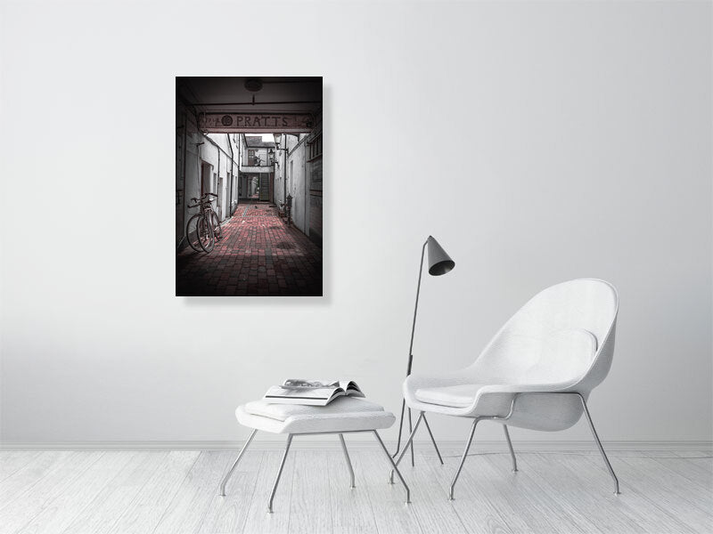 Quiet alleyway with vintage bicycle parked up. Print or framed art photography.