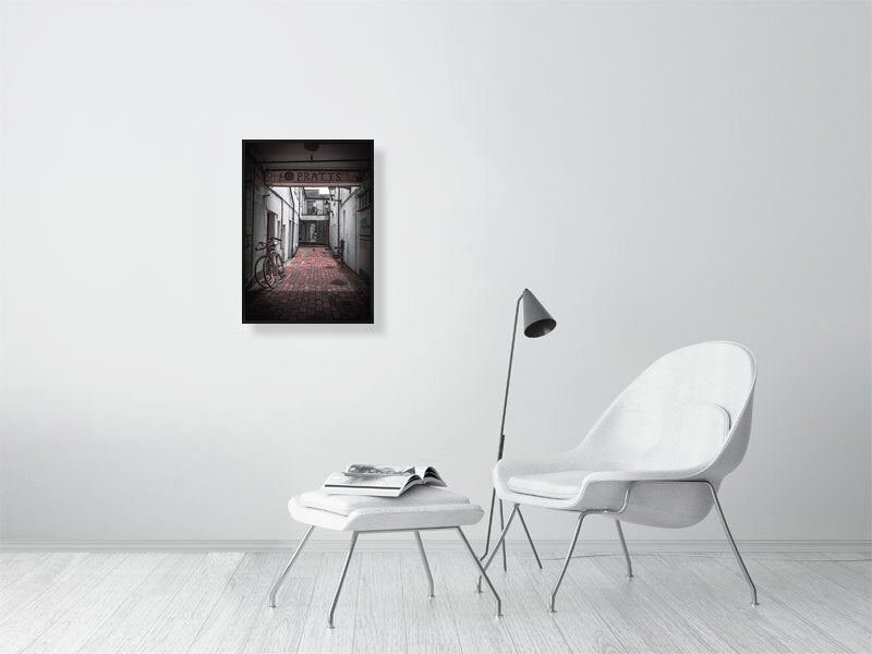 Quiet alleyway with vintage bicycle parked up. Print or framed art photography.