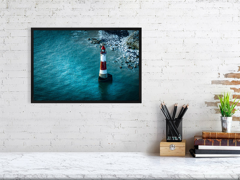 Lighthouse in blue waters of Eastbourne just off the cliff of Beachy Head, Eastbourne, East Sussex, UK