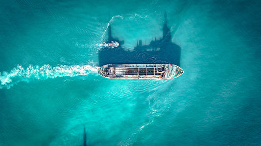 Cargo ship in a blue ocean on a clear, sunny day. Print or framed photography art.