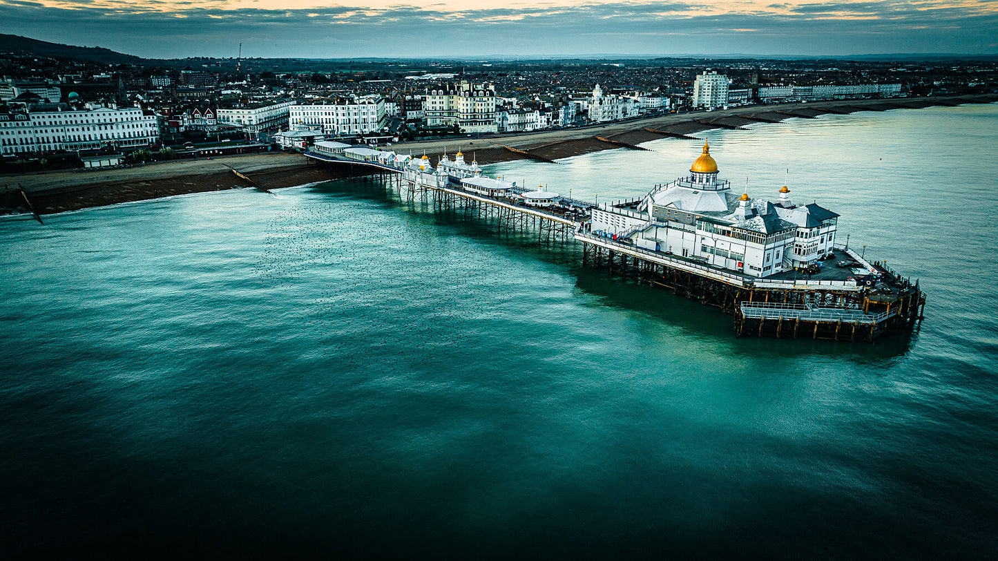 Eastbourne Pier accompanied by starling formation, evening bird murmuration, East Sussex, UK, Unframed print, photography art