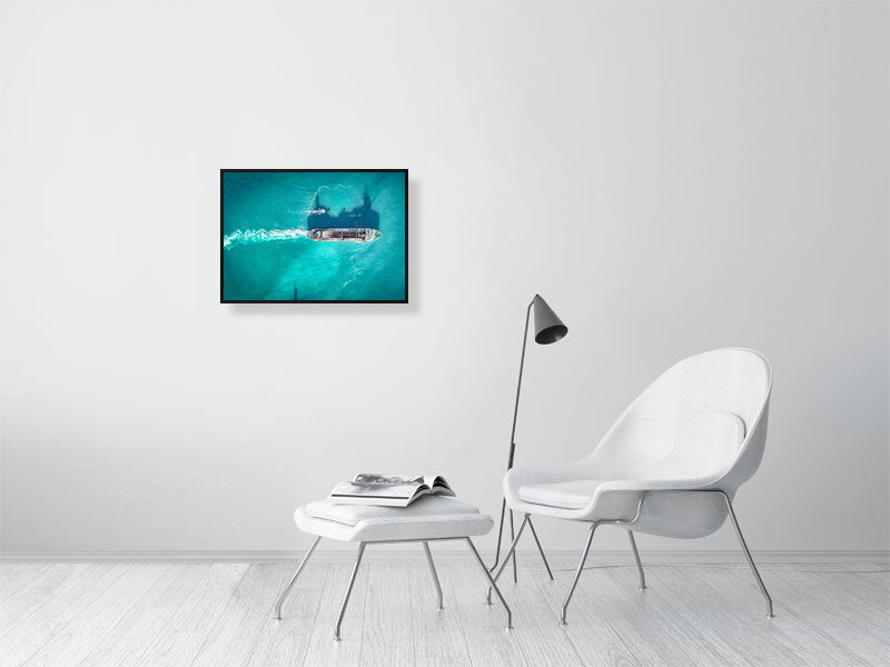 Cargo ship in a blue ocean on a clear, sunny day. Framed print, photography art.