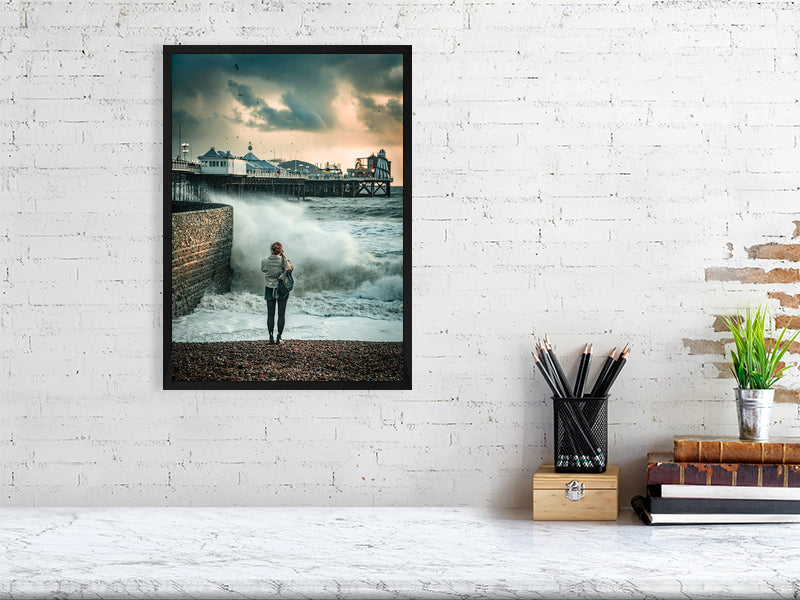 Random spectator watching waves on a windy autumn day by Brighton Pier. Print or framed photography art.
