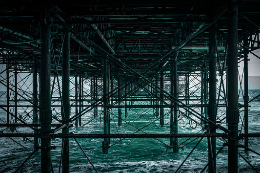 Base structure of Brighton Pier on a windy evening, Print or framed art photography.