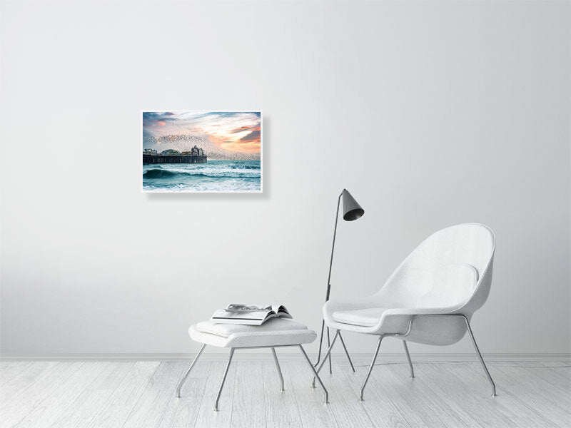 Starling murmuration over Brighton Pier on a windy evening. Print or framed photography art.