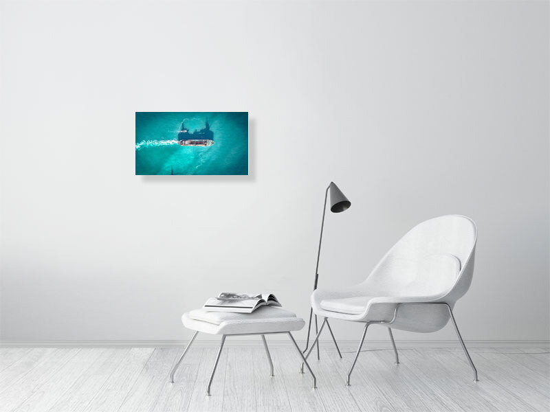 Cargo ship in a blue ocean on a clear, sunny day. Print, photography art.