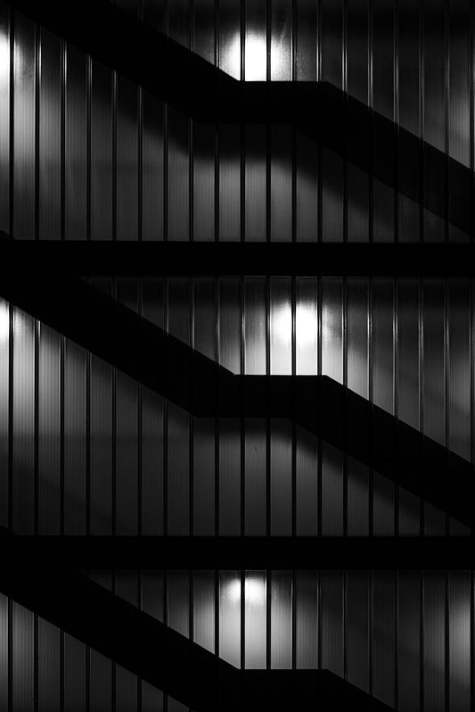 Stairs behind the glass at night. Print or framed art photography.