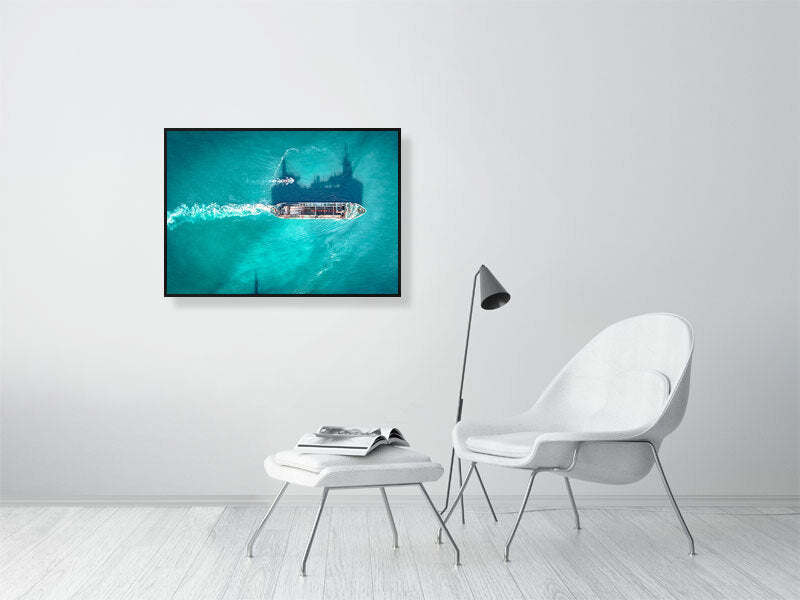 Cargo ship in a blue ocean on a clear, sunny day. Framed print, photography art.