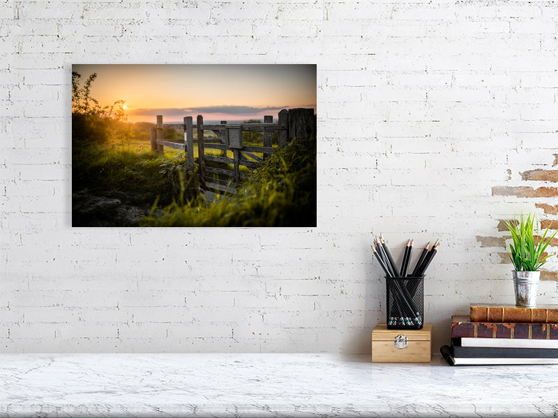 Gate in a wooden fence on a footpath toward a field on a tall hill close to Brighton. Printed or framed art photography.