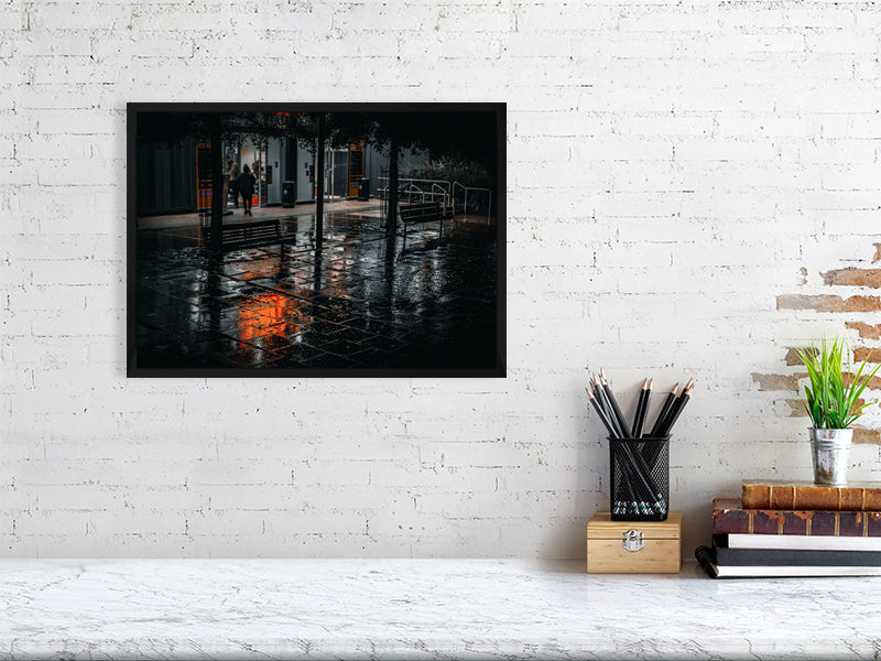 Neon light reflections on a wet pavement during heavy rain at night. Print or framed art photography.