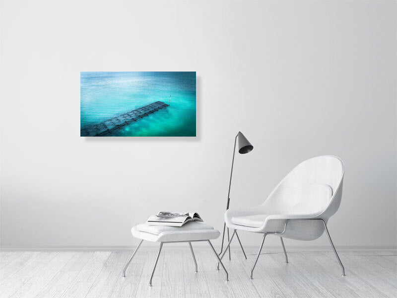 Blue waters of Lancing beach with remains of some wooden structure. Print or framed photography art.